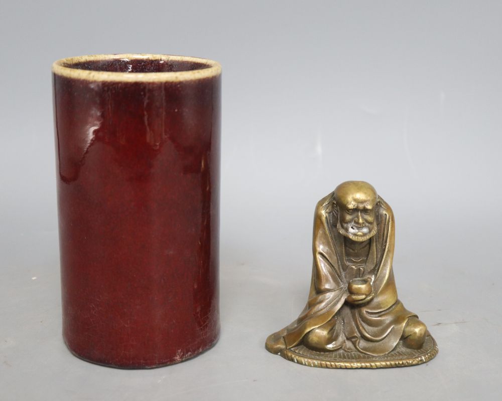 A sang de boeuf brush pot, height 15cm and a bronze deity